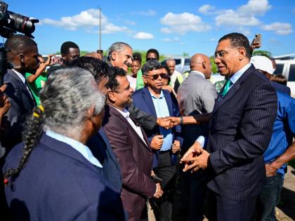 Prime Minister Dr Andrew Holness (right) greets shareholders of the Tropical Sugar Company Limited ahead of the ceremony to break ground for the new sugar factory in Chesterfield, Clarendon, on December 2.