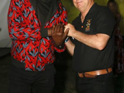 Richie Spice greets festival director Jason Henzell, moments after his surprise appearance.