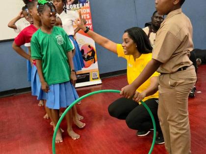 Dance Professor Renee Walters (second right) guides children through an activity at the GC Foster College’s inaugural Play for Recovery day at the school grounds yesterday.