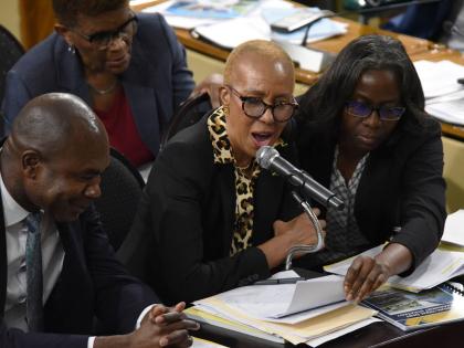 Minister of the Finance and the Public Service (MFPS) Fayval Williams (centre) answers questions during a sitting of the House of Representatives last Tuesday. Looking on are  Darlene Morrison (right), financial secretary, and Zavier Mayne, minister of sta