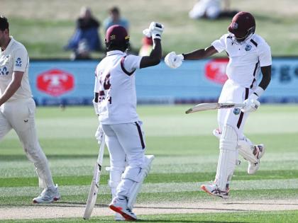 West Indies’ Justin Greaves (right) celebrates with teammate Kemar Roach (centre) after scoring 200 runs against New Zealand on day five of their cricket Test match in Christchurch, New Zealand, on Saturday.