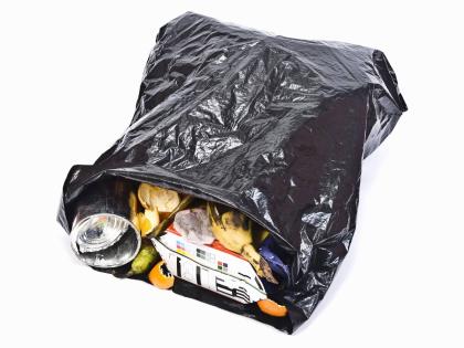 A plastic bag with rubbish for disposal.