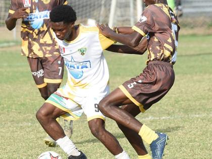 Ian Allen/photographer 
Excelsior High School’s Kimarly Scott (centre) tries to get past Charlie Smith’s Devonte Wilson during their ISSA/WATA Manning Cup quarter-final encounter at Winchester Park yesterday. Looking on is Charlie Smith’s Orlando Gra