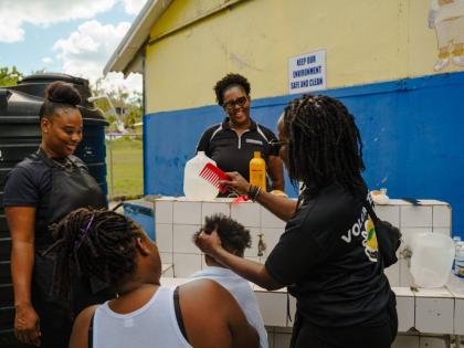 United4GoodJA volunteers provide grooming services to a young shelter resident in Westmoreland.
