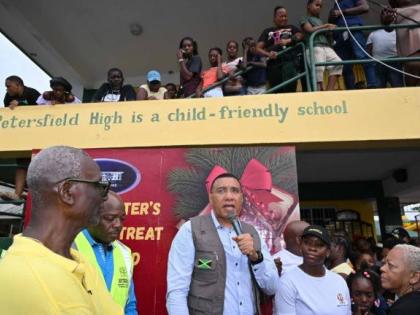 Prime Minister Dr Andrew Holness (centre) addressing residents at the Petersfield High School in Westmoreland on Saturday, December 13, 2025 during the Prime Minister’s Christmas Treat. Also participating were (from left) Minister of Local Government and