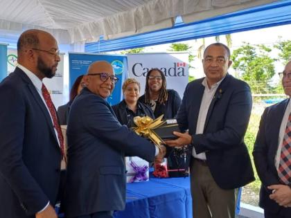 Health and Wellness Minister, Dr Christopher Tufton (second right), accepts Electronic Immunisation Registry equipment from Monitoring and Evaluation Specialist at UNICEF, Dr Paul Edwards (second left), during a handover ceremony held at the St Ann Healt