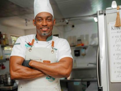 Chef Durren McClean, managing director of Surf and Turf Catering, poses with his D&G Sorrel Rum glazed ham.