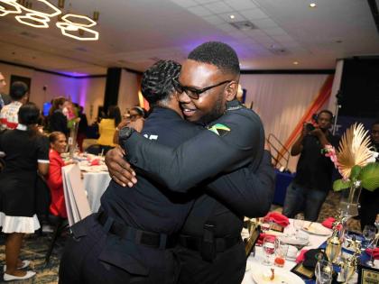 Shantel Powell (left), winner of the 2025 top cop award, is embraced by Corporal Rojehn Holt, first runner-up, during the Lasco Chin Foundation/Jamaica Constabulary Force Saluting Our Heroes Awards ceremony held yesterday at The Jamaica Pegasus hotel in Ne