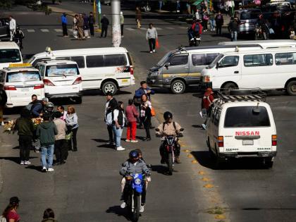 People walk during strike by the public transportation sector in La Paz, Bolivia, Friday, December 19, 2025, after President Rodrigo Paz announced the end of fuel subsidies. (AP Photo/Freddy Barragan)