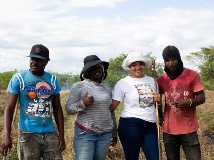 Latoya Burrows-Johns (second right), owner of LD Promise Farms, shares a photo with employees (from left) Kenroy Ricketts, Vivine Haslam and Glen Shirley.