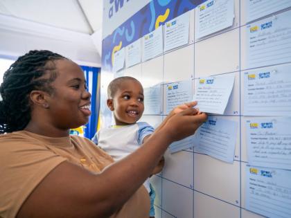 A mother and son share smiles as they review their wish on the Wishing Wall during the NCB Foundation’s Grant a Wish launch, held recently at NCB’s Fairview Financial Centre in Montego Bay, St James. 