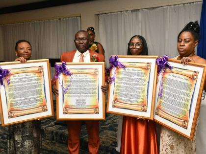 The four retired educators at the St Catherine-based Jonathan Grant High School, display their citations. They are (from left) Textbook Administrator, Ivorene Neil; Vice Principal, James Davis; Internal Examination Coordinator, Olive Simms; and Textbook Ad