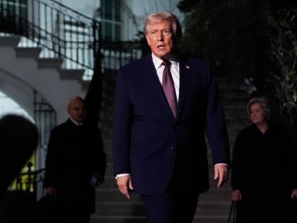 President Donald Trump walks to speak with reporters while departing the White House as chief of staff Susie Wiles, right, looks on, Friday, December 19, 2025, in Washington. (AP Photo/Julia Demaree Nikhinson)