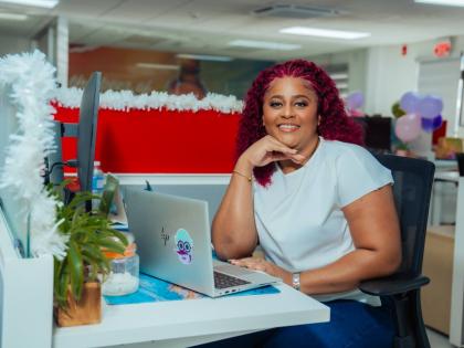 Alisha Distant paused from her work at her desk for a quick photo op.