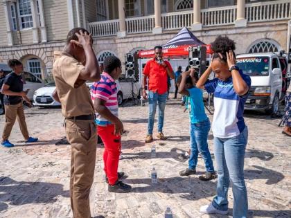 People engage with JN+ staff members during their health camp at Sam Sharpe Square in Montego Bay.