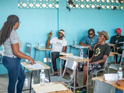 Kelly Griffith, training coordinator  at Project STAR, leads an interactive training session as participants engage in discussion during the Project STAR, UNDP Cash for Care & Work Initiative in Savanna-la-Mar, Westmoreland.