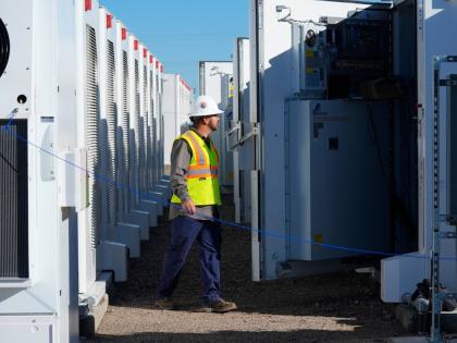 A worker does checks on battery storage pods at Orsted’s Eleven Mile Solar Center lithium-ion battery storage energy facility Feb. 29, 2024, in Coolidge, Ariz. AP
