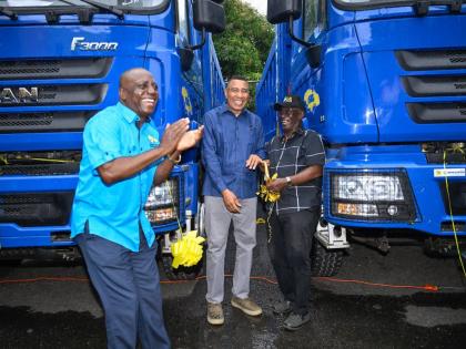 Prime Minister, Dr Andrew Holness (centre); Minister of Local Government and Community Development,  Desmond McKenzie (right); and Executive Director of the National Solid Waste Management Authority (NSWMA), Audley Gordon, celebrate the addition of 10 new 