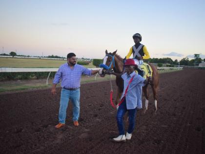 
WE JAMMIN, with Omar Walker in the saddle, is flanked by trainer Peter-John Parsard (left) and groom Frank Spencer after capturing the Wayne DaCosta OD Two-year-old Stakes over a mile at Caymanas Park on December 26, 2025.