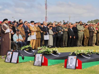People attend funeral prayers for General Muhammad Ali Ahmad al-Haddad, coffin at left, in Misrata, Libya, who was killed with others in a plane crash.