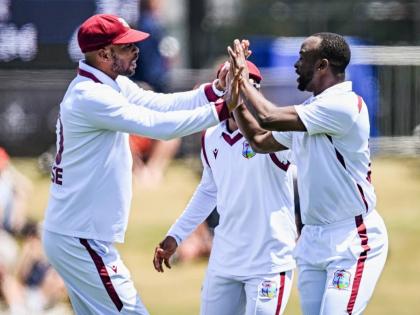 West Indies fast bowler Kemar Roach (right) and captain Roston Chase celebrate the wicket of New Zealand’s Kane Williamson during the recent first Test match between the two teams  in Christchurch, New Zealand, on Thursday, December  4. 