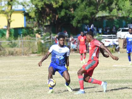 Mount Pleasant Academy’s Raheem Edwards (left) is challenged by Montego Bay United’s Philando Wing) during their Jamaica Premier League game at Jarrett Park yesterday. 