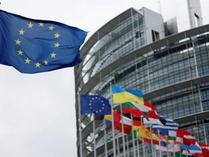 The European flag, left, flies at the European Parliament in Strasbourg, eastern France.