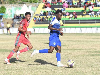 Mount Pleasant Football Academy’s Kyle Ming (right) tries to outrun Montego Bay United’s Timar Lewis during their Jamaica Premier League game at Jarrett Park on Sunday. Mount Pleasant won 1-0.