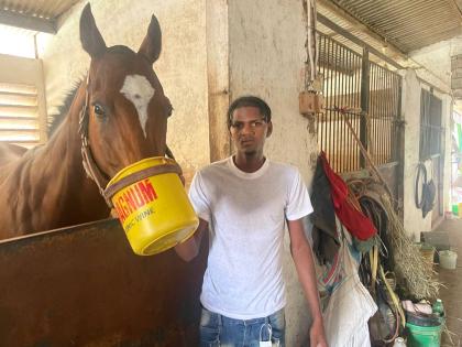 Champion groomsman Coby Anthony hangs out with RUM WITH ME at Caymanas Park on Monday.