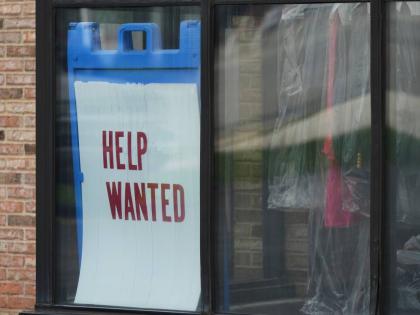 A ‘Help Wanted’ sign is displayed at a dry cleaner in Rolling Meadows, USA, in May 2025. 