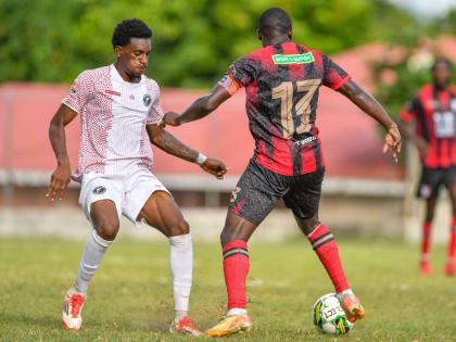 Damoi Kaschief Whitfield (left) of Chapelton Maroons tries to stop the advance of Fabian Reid of Arnett Gardens during a Jamaica Premier League match at Turner’s Oval in Clarendon on September 14, 2025.