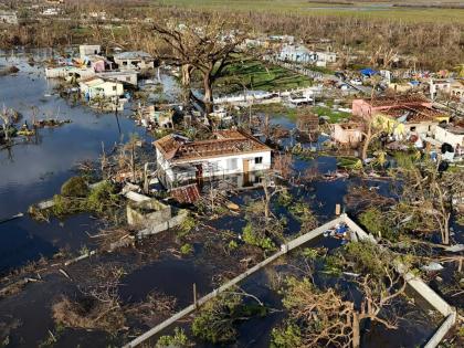 Debris surrounds damaged homes along the Black River, Jamaica, on October 30, 2025, in the aftermath of Hurricane Melissa.