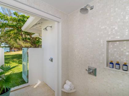 All bathrooms are air-conditioned. This one showcases the walk-in, indoor-outdoor open-air rain showers.