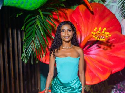 Above: Business Owner Gabrielle Suglam wears a two-tone draped maxi dress from House of CB.