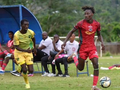 
Montego Bay United’s Deonjay Brown (right) dribbles away from Treasure Beach FC’s Chandol Anderson during their Jamaica Premier League football match at St Elizabeth Technical High School on January 4.