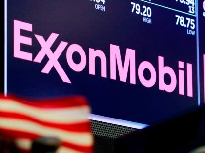 The logo for ExxonMobil appears above a trading post on the floor of the New York Stock Exchange, April 23, 2018. (AP Photo)