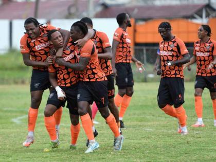 Akeil Leachman (second left) of Tivoli Gardens FC is congratulated by his teammates after scoring the first goal during their Jamaica Premier League football match against Portmore United at the Edward Seaga Sports Complex in Kingston yesterday. The game e