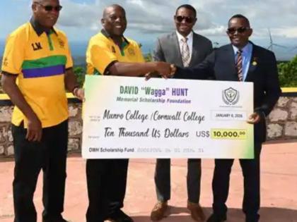 
From left: David ‘Wagga’ Hunt Foundation committee members, Leighton ‘Fyah’ McKnight and Garth Pottinger, present a cheque for US$10,000 to principals, Dr Mark Smith and Michael Ellis of Munro College and Cornwall College, respectively. 