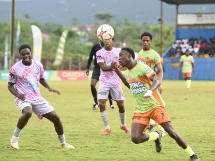 Ashley Anguin/Photographer 
All daCosta Selection and Cedric Titus’s Terron Eccleston (right) uses his head to control a ball while being closely watched by Kevaun Campbell during their ISSA All-daCosta vs All-Manning Selection football at the STETHS Spo