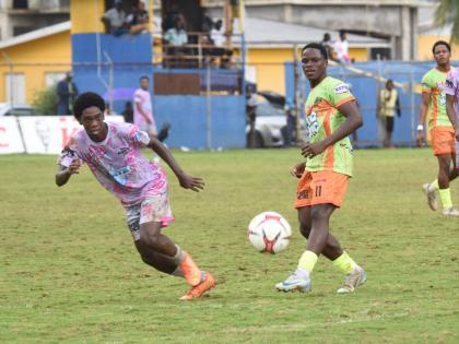 
All-Manning Selection’s and Jamaica College’s Dujoni Thompson (left) and All-daCosta Selection’s and Kemps Hill High’s Shemar Daley’s chase a ball during their ISSA All-daCosta vs All-Manning Cup match at the STETHS Sports Complex  yesterday.