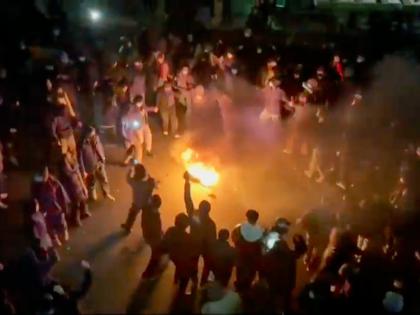 In this frame grab from footage circulating on social media shows protesters dancing and cheering around a bonfire as they take to the streets despite an intensifying crackdown as the Islamic Republic remains cut off from the rest of the world, in Tehran, 