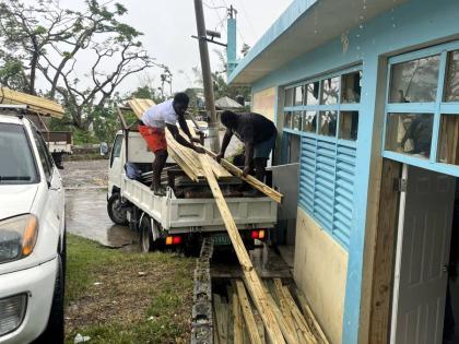 Residents are seen assisting in rebuilding efforts in Maryland and Cottage Road, as part of the JMMB Joan Duncan Foundation’s Community Restart Project .