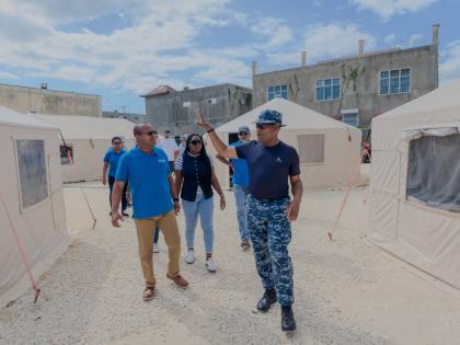 Anderson Goodridge (right), emergency medical team commander of the Barbados Defence Force, walks Petrojam’s management team, led by Telroy Morgan (left), general manager, medical volunteers, and Savanna-la-Mar Hospital staff through a tour of the field 