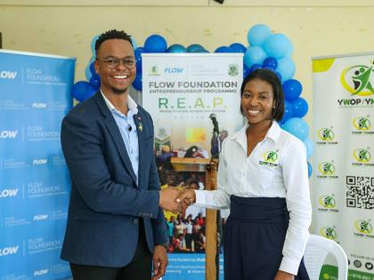 Executive Director of the Flow Foundation Rhys Campbell and Executive Director of the Young Women and Men on Purpose initiativ, Lanisia Rhoden seal their agreement with a handshake at the launch of the Flow Foundation REAP Entrepreneurial programme on Janu