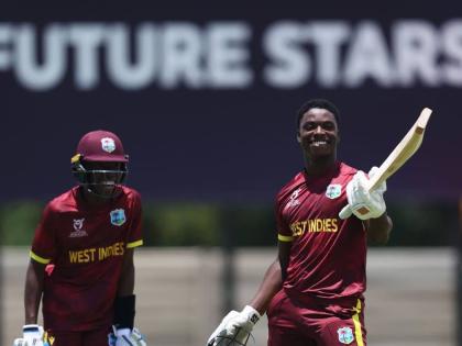West Indies U19 batsman Shamar Apple (right) celebrates a century against Japan, while Tanez Francis, who also scored a hundred, looks on during an ICC U19 Cricket World Cup warm-up game at the United Cricket Ground in Windhoek, Namibia, yesterday.