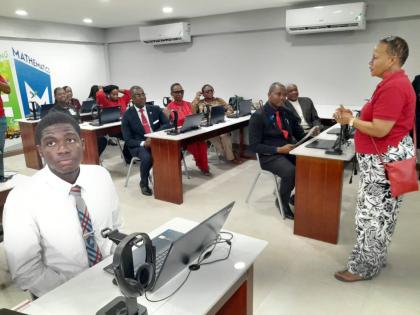 Coleen Lyn (right),vice-president, Colfax Mart Ltd, a division of Digicel, outlines features of the SMART Lab to teachers and students following its presentation to Sam Sharpe Teachers’ College recently. 