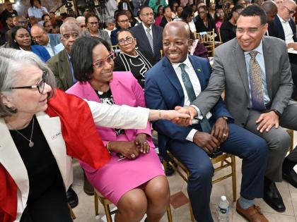 Prime Minister Dr Andrew Holness (right) greets Kate Forbes (left), president of the International Federation of Red Cross and Red Crescent Societies, while looking on are Dionne Jennings, permanent secretary in the Ministry of Labour and Social Security, 