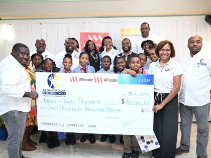 Principal director of Cause for Change Foundation Limited, Richardo Aiken (left), and CEO of VM Foundation, Samantha Charles (second right), present the winning cheque to students of Brown’s Town Primary who won the finals of the Environmental Quiz and E