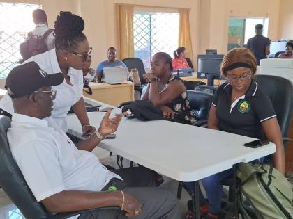 Local Government Minister Desmond McKenzie (left) in discussion with employees of the St Elizabeth Municipal Corporation.