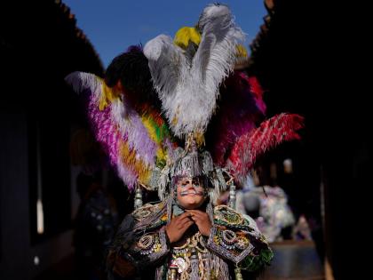 A dancer adjusts his costume before taking part in a procession honouring St Thomas, the patron saint of Chichicastenango, Guatemala.